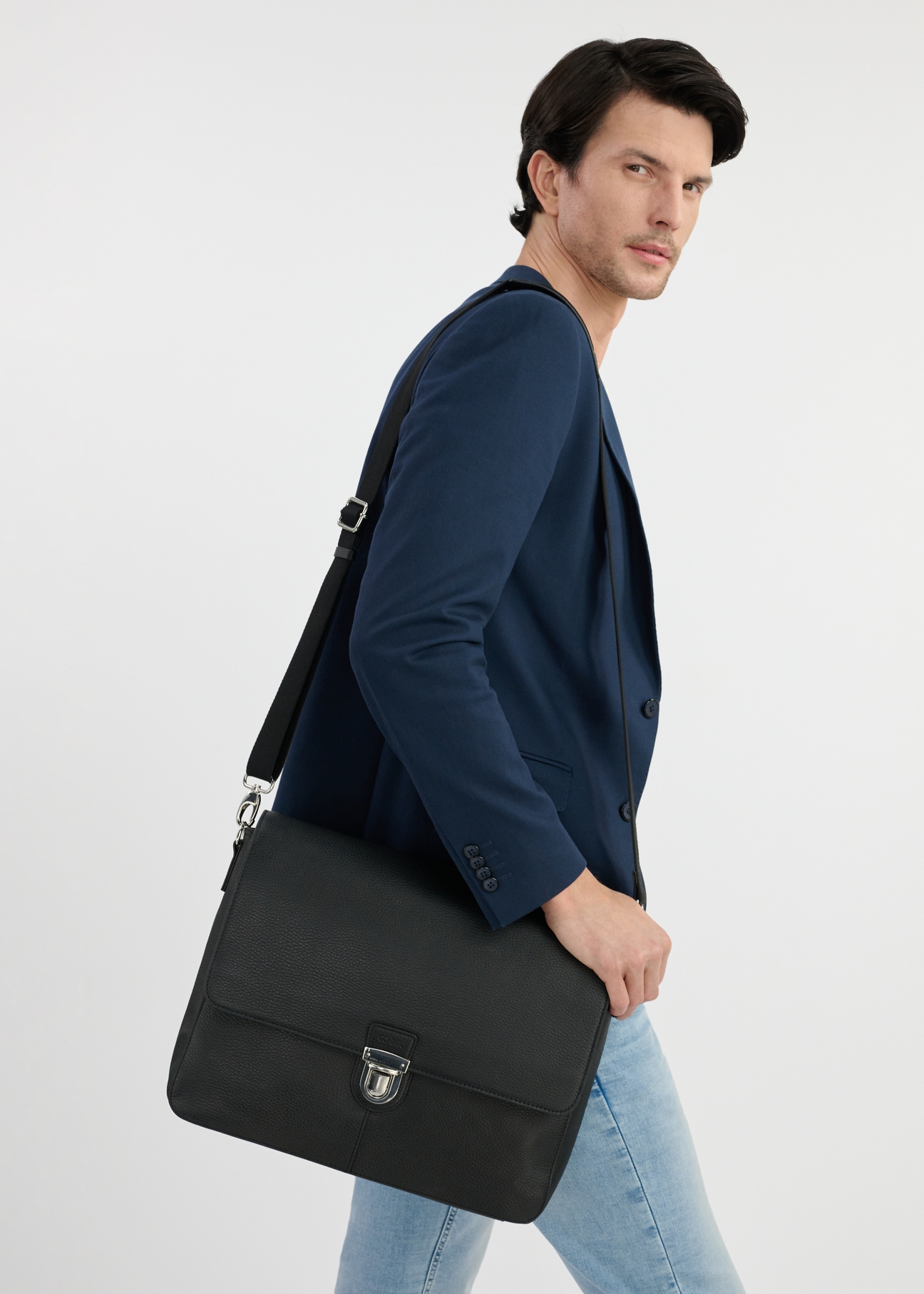 Black leather men's document briefcase TORMS-0449-99(W25), front product view on the model. Half of the silhouette visible.