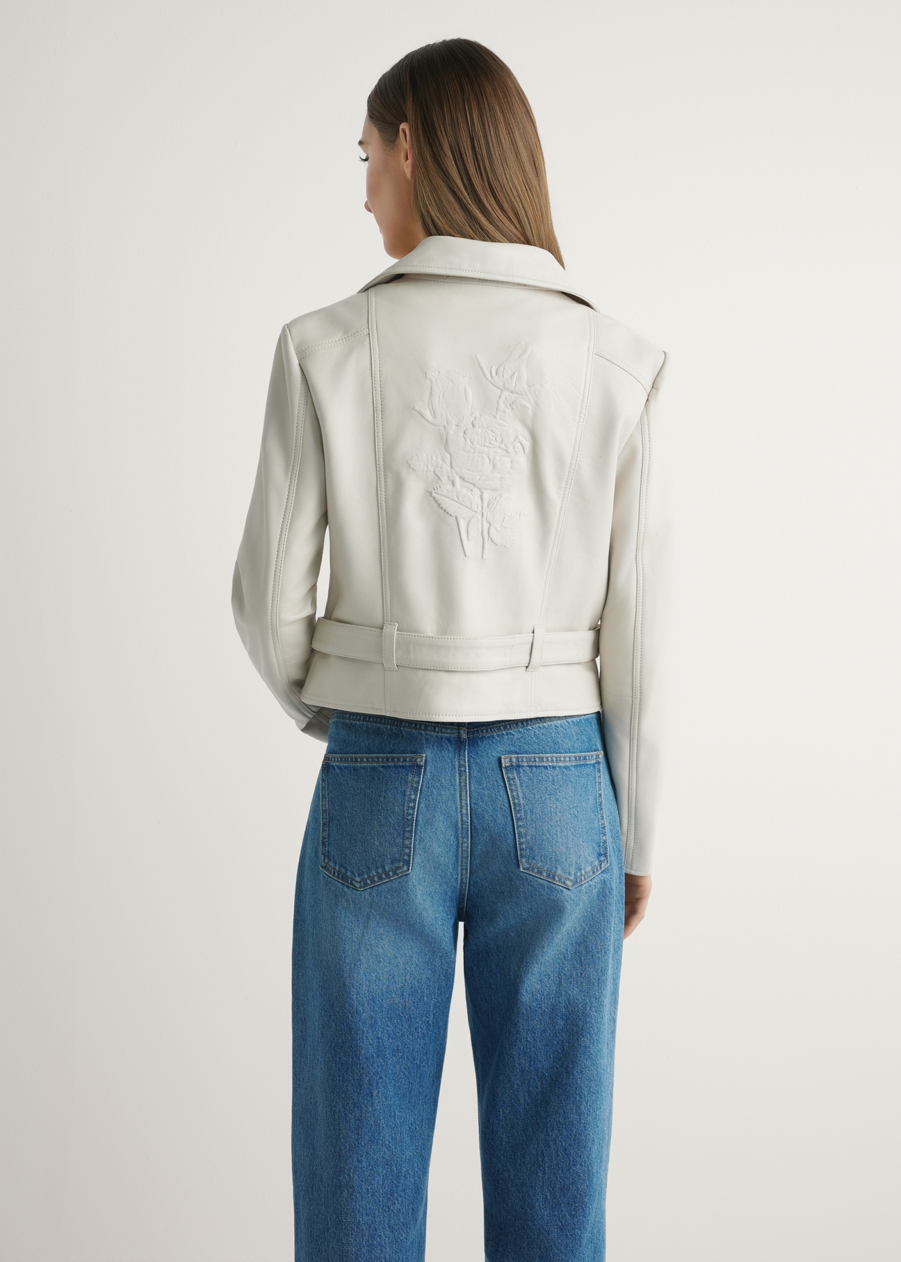 Women's cream leather biker jacket KURDS-0585-0B(W26) - back view of the product, on a model, against a light background. Half of the silhouette visible.