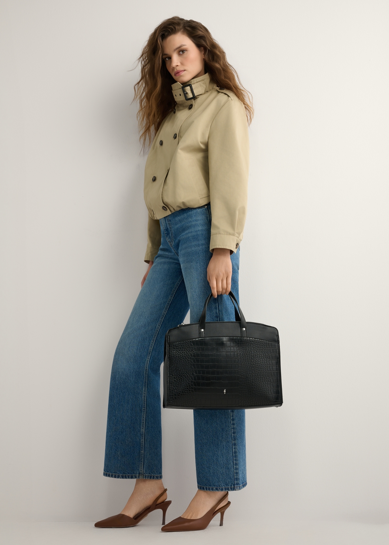 Black women's croco bag TOREC-1143-9G(W26), product view in model's hand. Full body visible.