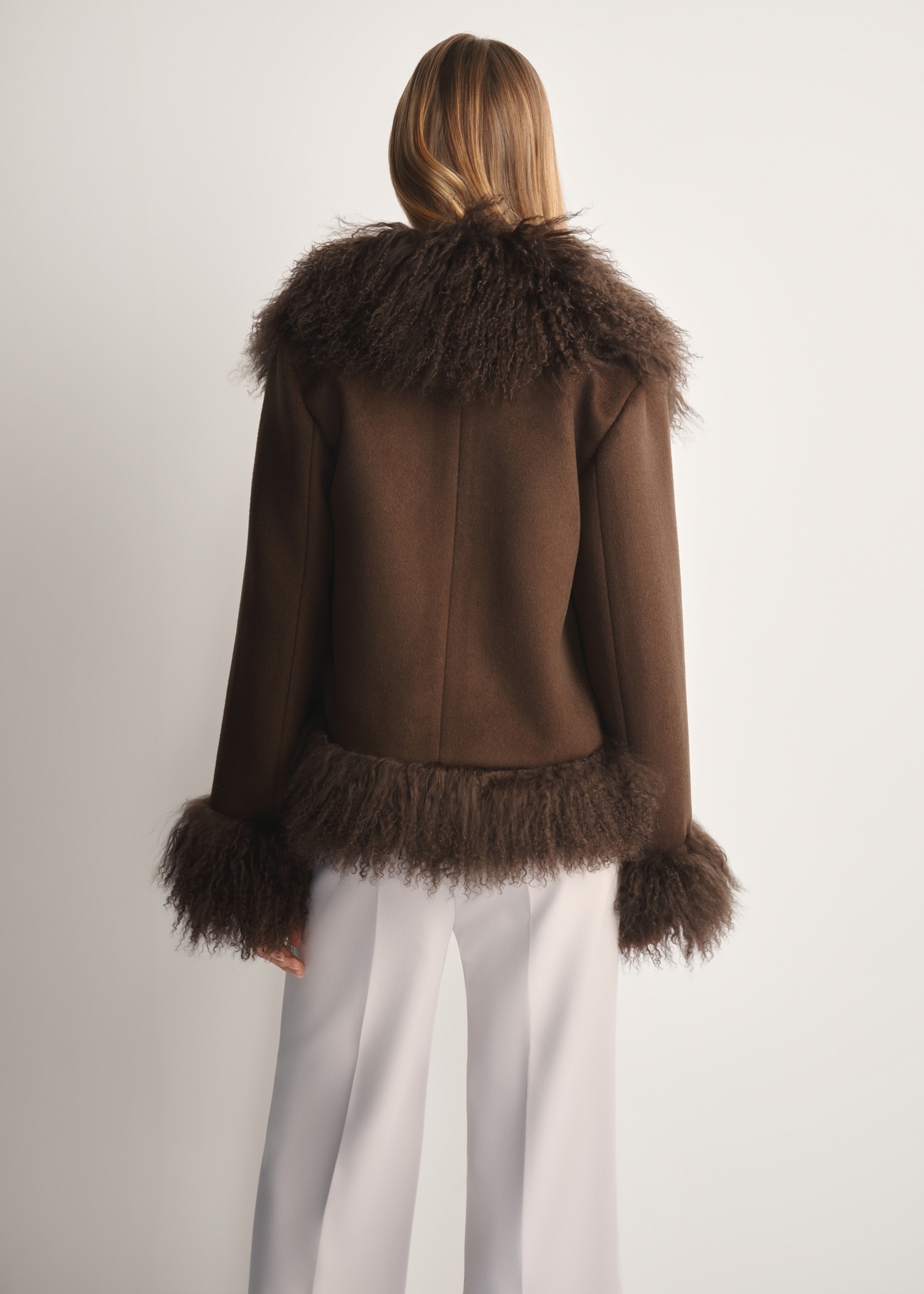 Brown woolen women's fur coat FUTDF-0113-3182(Z25) - product view from the back on the model on a white background. Half of the silhouette visible.