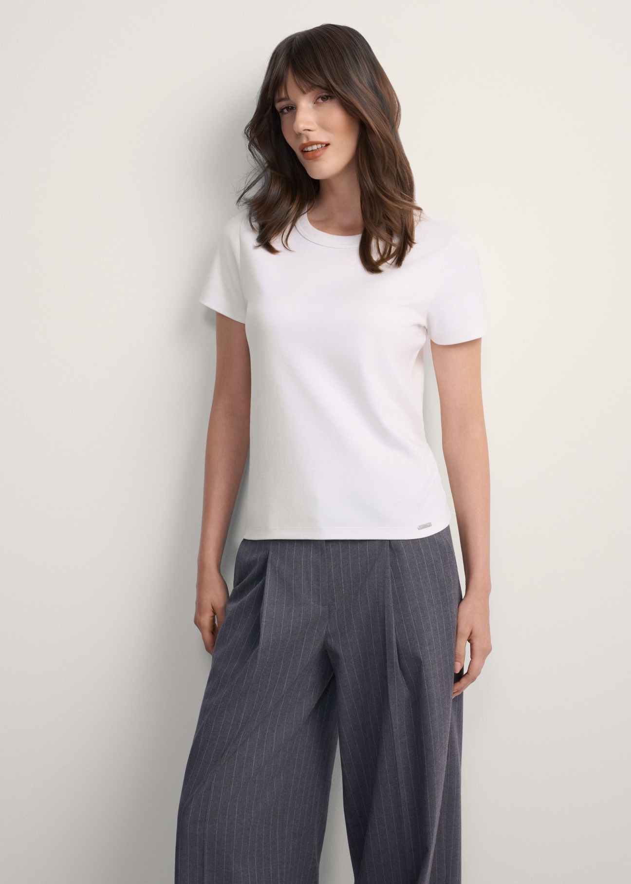Women's white cotton t-shirt TSHDT-0144-0B(Z26), front view of the product on the model, half of the silhouette visible.