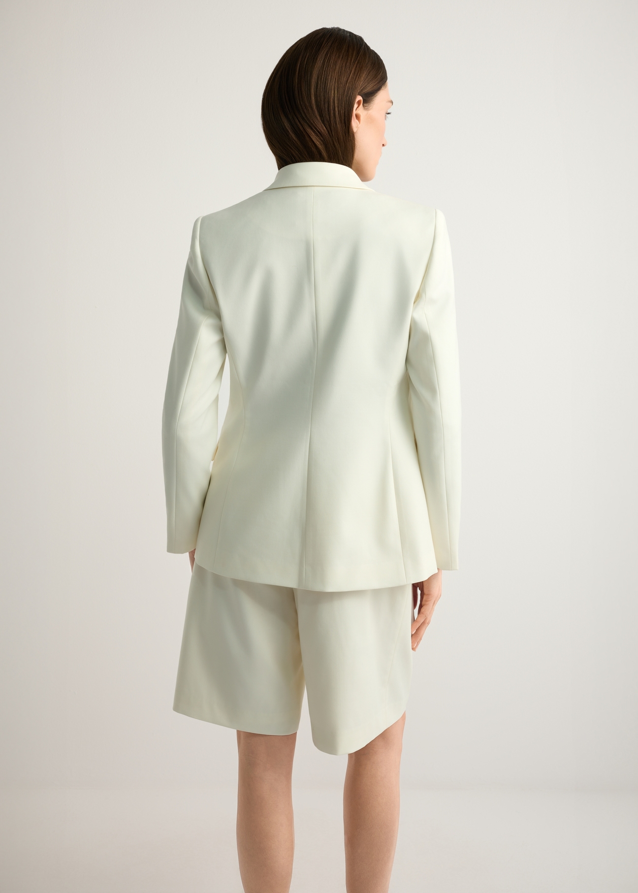 Women's white wool-blend blazer ZAKDT-0045-0B(W26), back view of the product on the model. Half of the silhouette visible.