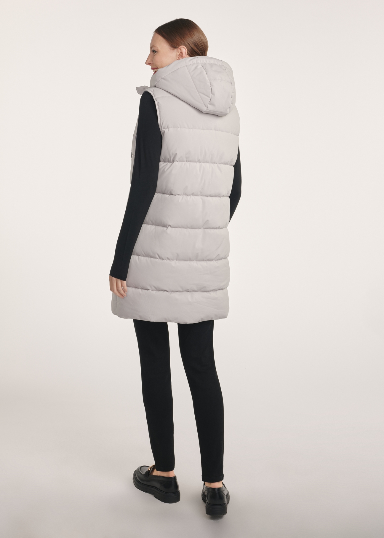 Gray long women's vest KAMDT-0034-91(Z25), product view from the back on the model, the whole silhouette is visible.