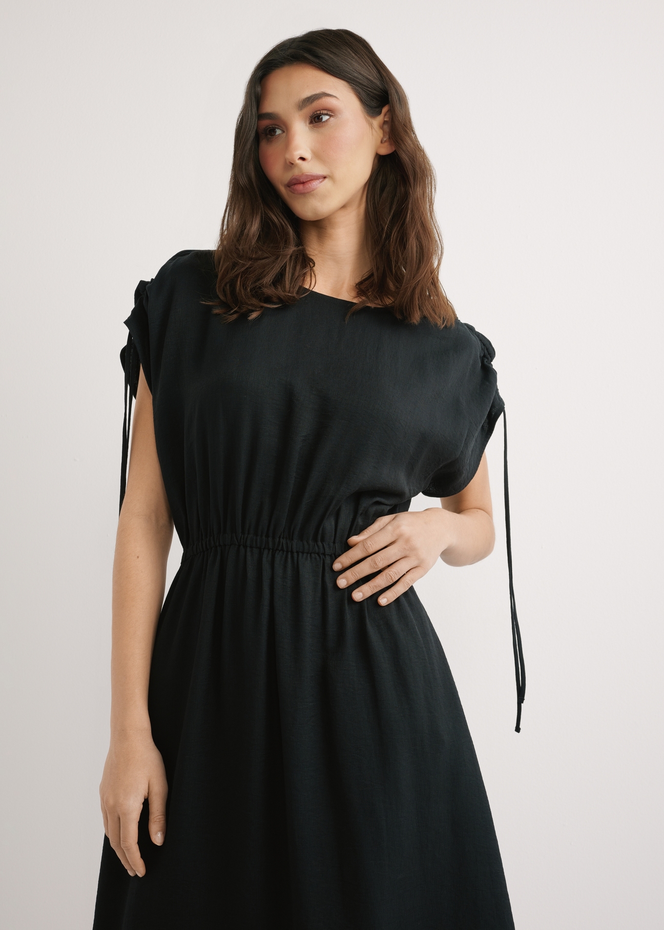 Black long dress with short sleeves SUKDT-0225-99(W26), front view of the product on the model. Half of the silhouette visible.