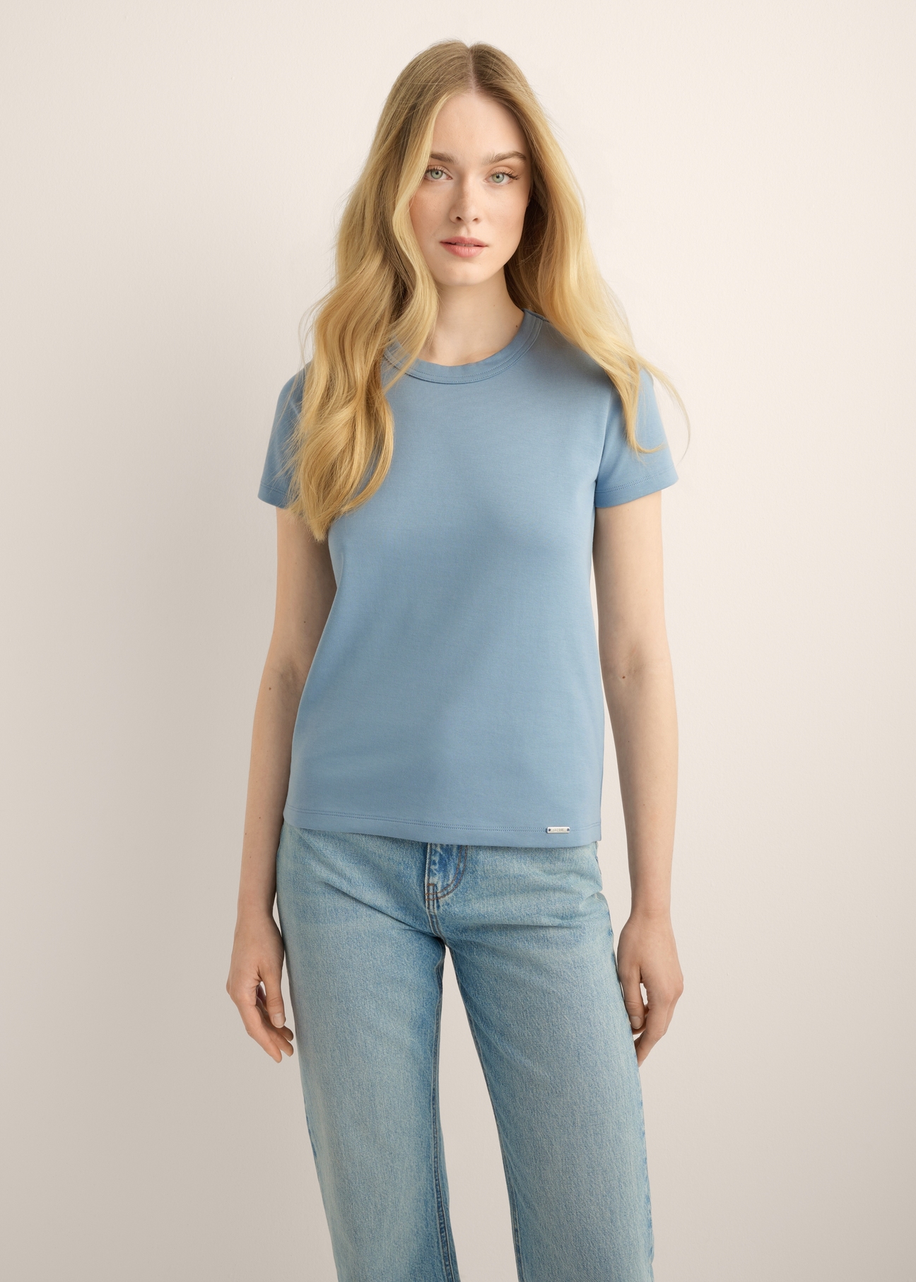 Blue cotton women's T-shirt TSHDT-0144-7B(Z26). Front view of the product on a model. Half of the figure is visible. (2)