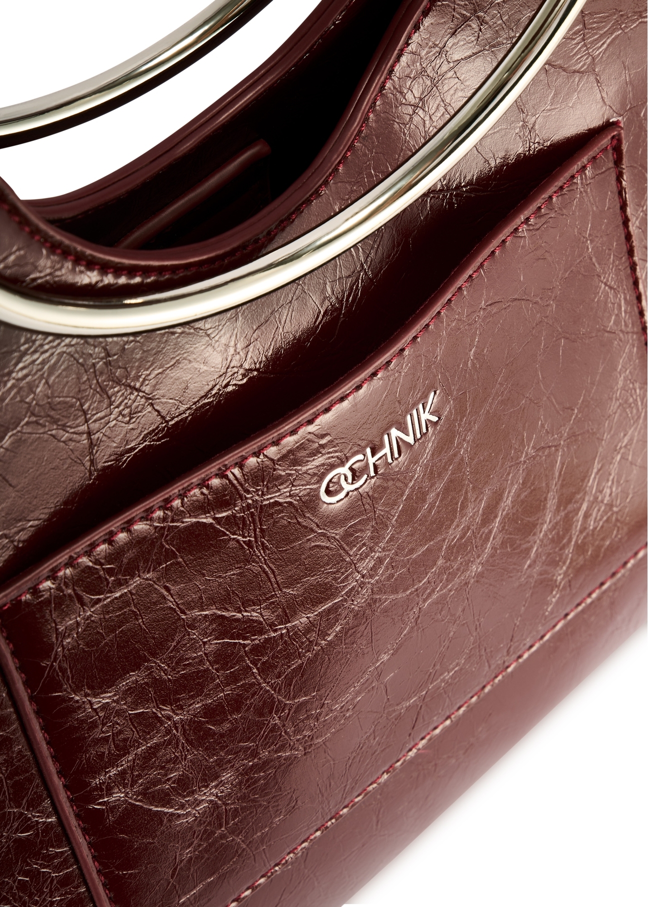 Burgundy women's handbag TOREC-0728A-49(Z25), close-up of the product pocket, view on a white background.