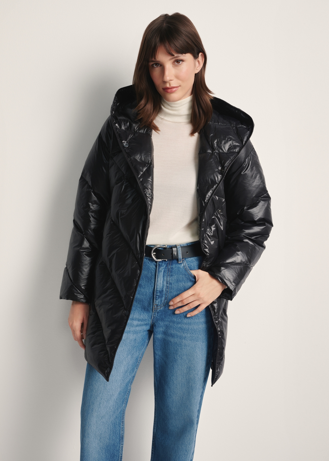 Black women's quilted jacket KURDT-0595-99(Z25), front view of the product on the model, half of the silhouette visible.-02