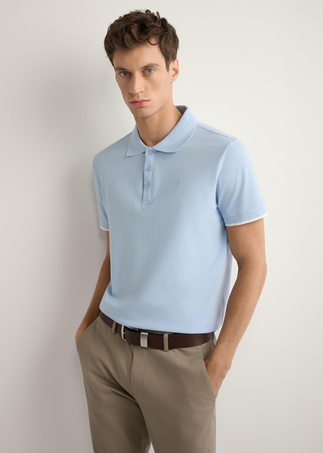 Light blue cotton polo shirt POLMT-0045B-7A(W26), front view of the product on the model. Half of the silhouette visible.
