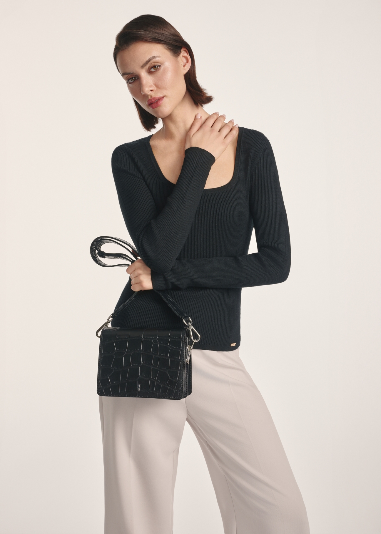 Black croco leather handbag TORES-1176-99(Z25), product view on a model, half of the silhouette visible.