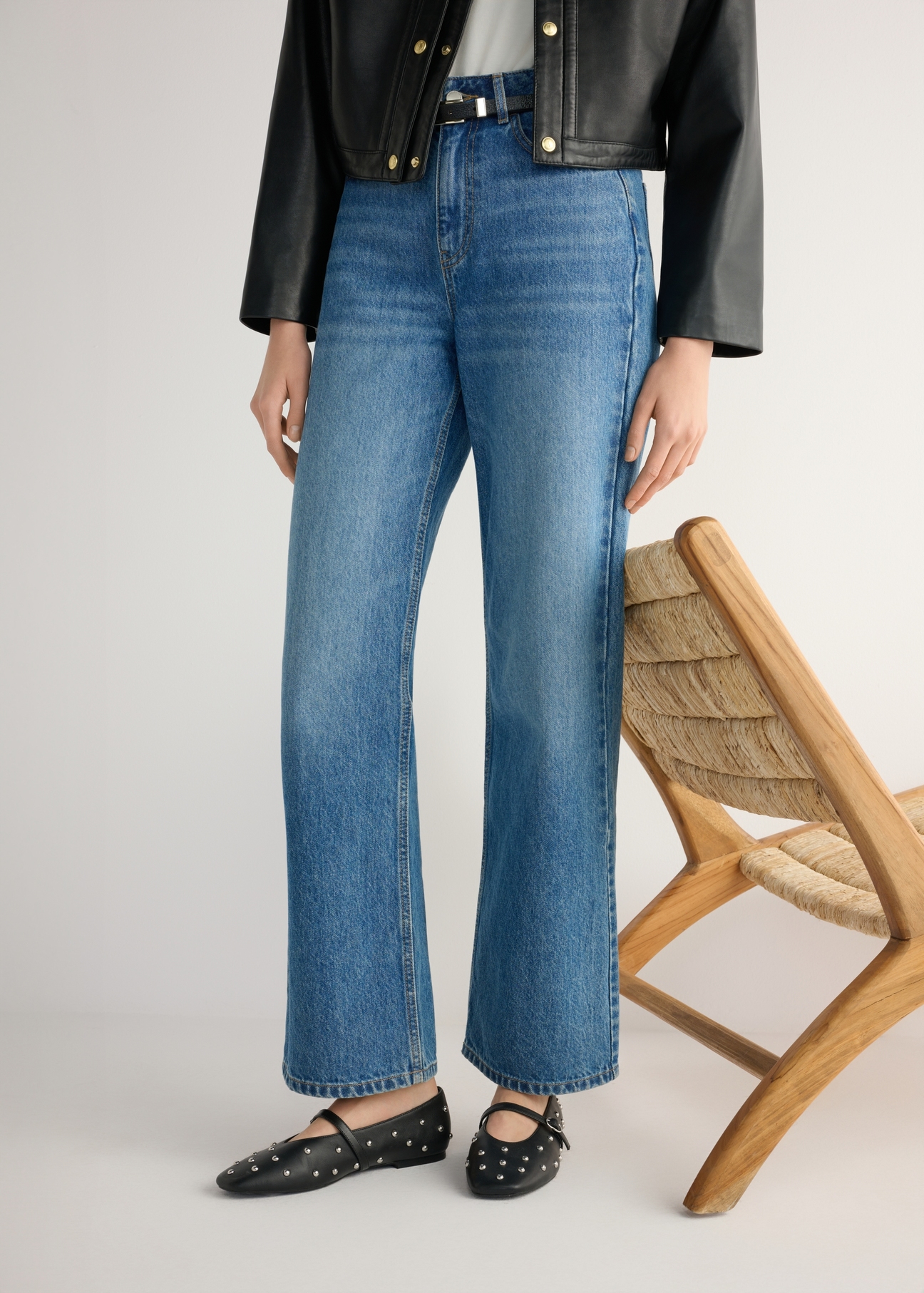 Women's black leather ballet flats with rhinestones BUTYD-1235-99(W26), product view from the front on the model, half of the silhouette visible.