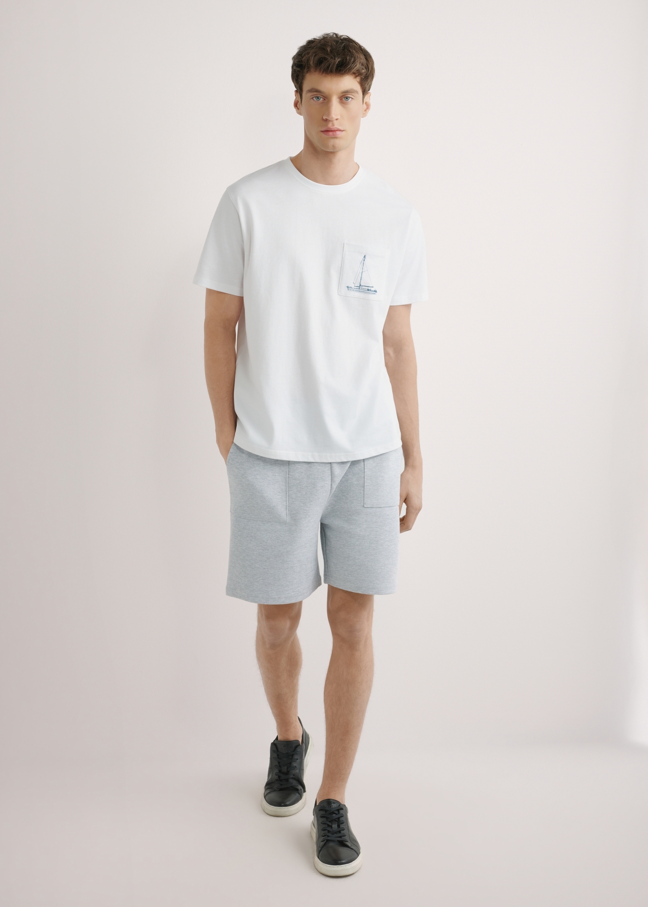 Men's white T-shirt with print TSHMT-0145-0A(W26), front view of the product on the model. Full body visible.