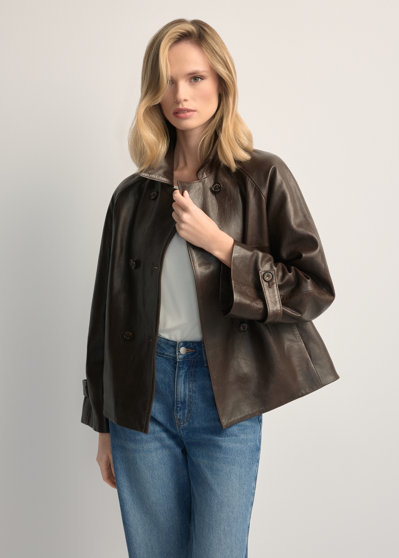 Women's dark brown leather jacket KURDS-0604-1I(W26), front view of the product on the model. Half of the silhouette visible.