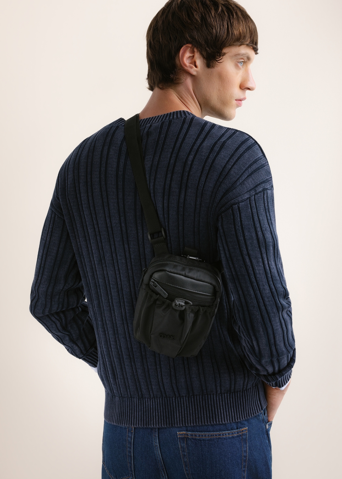 Men's city crossbody bag TORMN-0428-99(Z26), front view of the product on the model. Half of the silhouette visible.