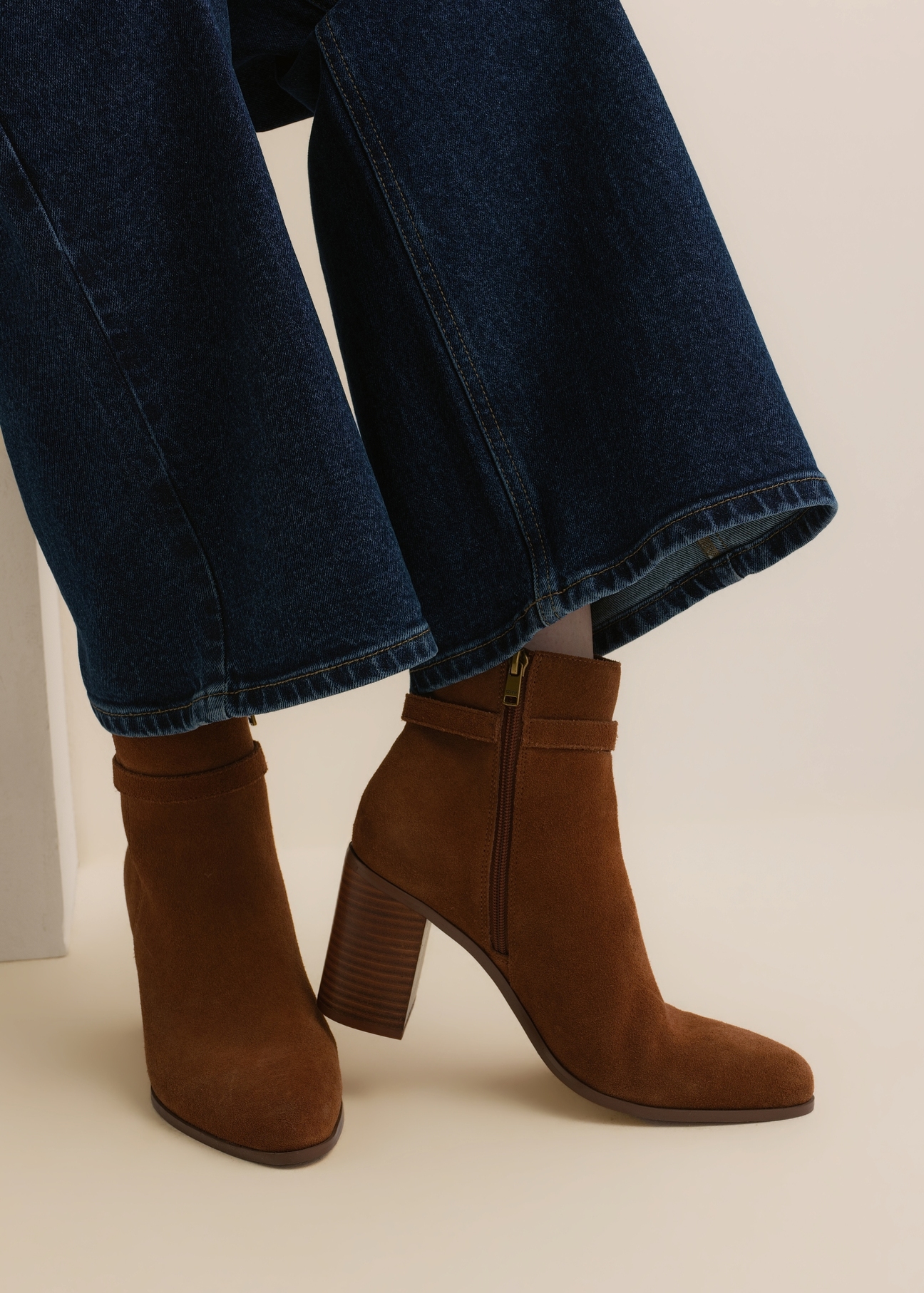 Women's cognac suede ankle boots with a logo (model BUTYD-1214-1F(Z26)); side view of the product on a model's feet, against a light background.