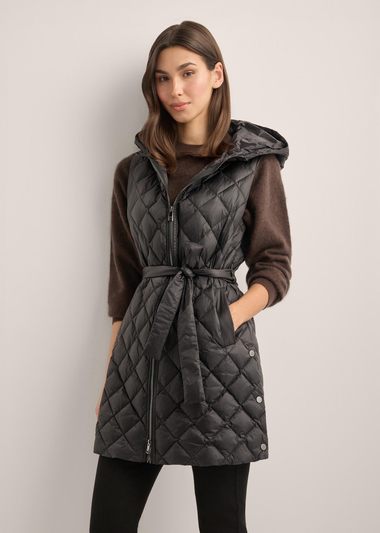 Women's black quilted vest KAMDT-0041-99(Z26), front view of the product on the model. Half of the silhouette visible.