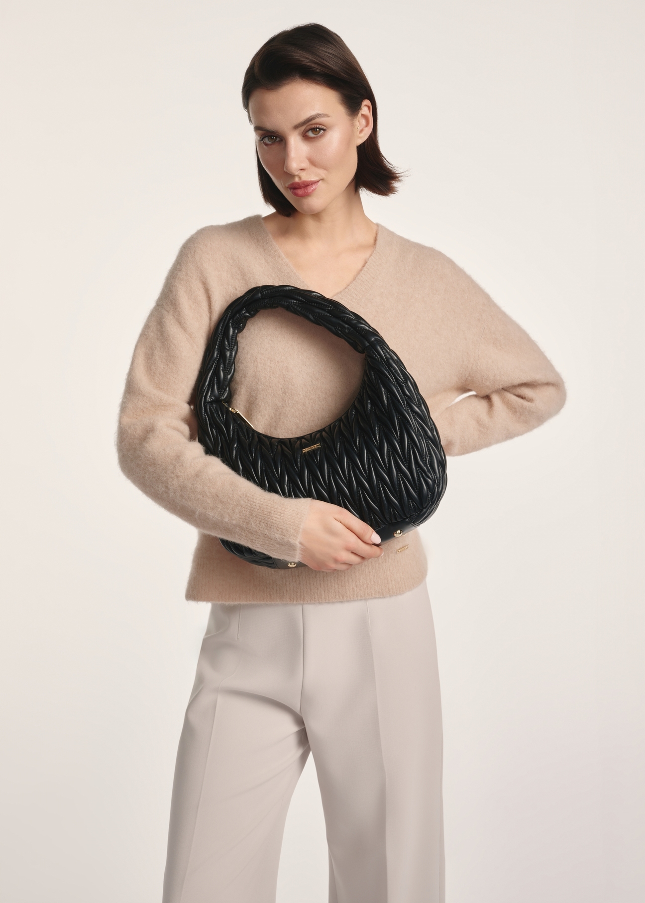 Black women's shoulder bag TOREC-1101-99(Z25) - front view of the product on a model against a white background. Knee-length silhouette visible.