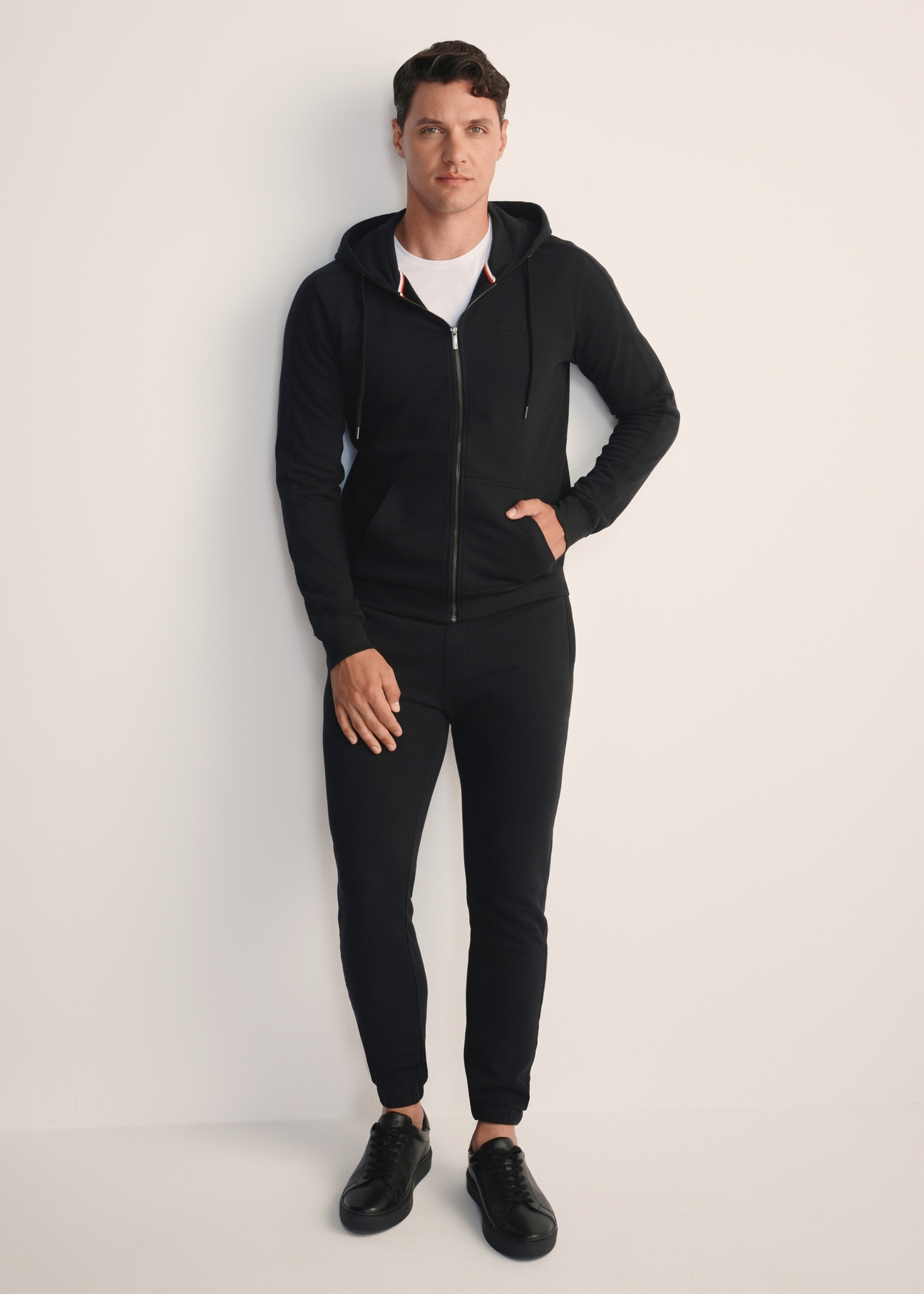 Black men's sweatpants SPOMT-0101-99(Z25), product view from the front on the model, the entire silhouette is visible.