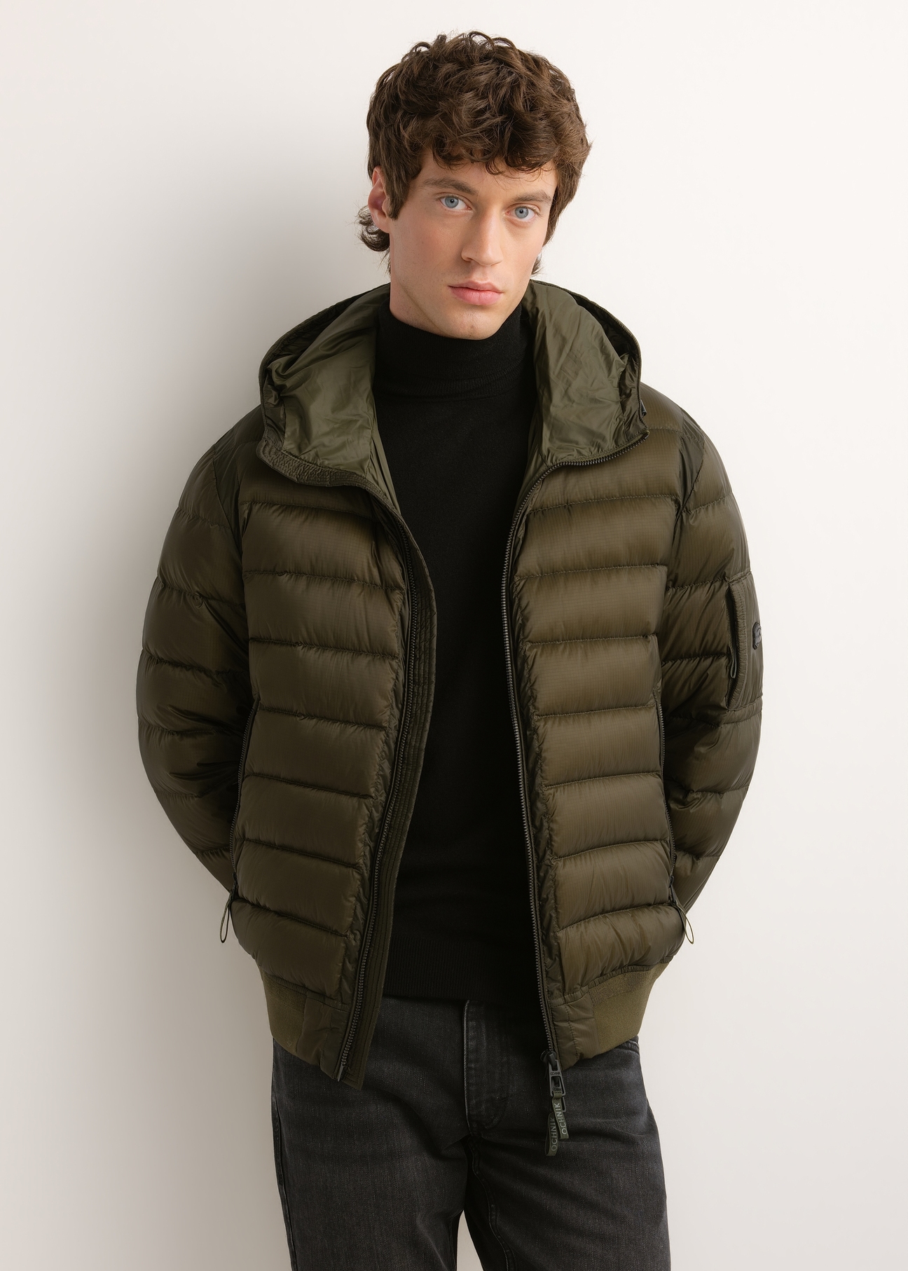 Men's green nylon jacket KURMT-0608-8B(Z26), front view of the product on the model. Half of the silhouette visible.