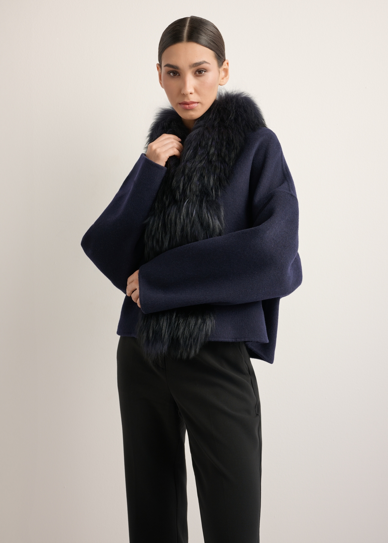 Women's short wool fur coat in navy blue FUTDW-0038-7E(Z26), front view of the product on the model. Half of the silhouette visible.
