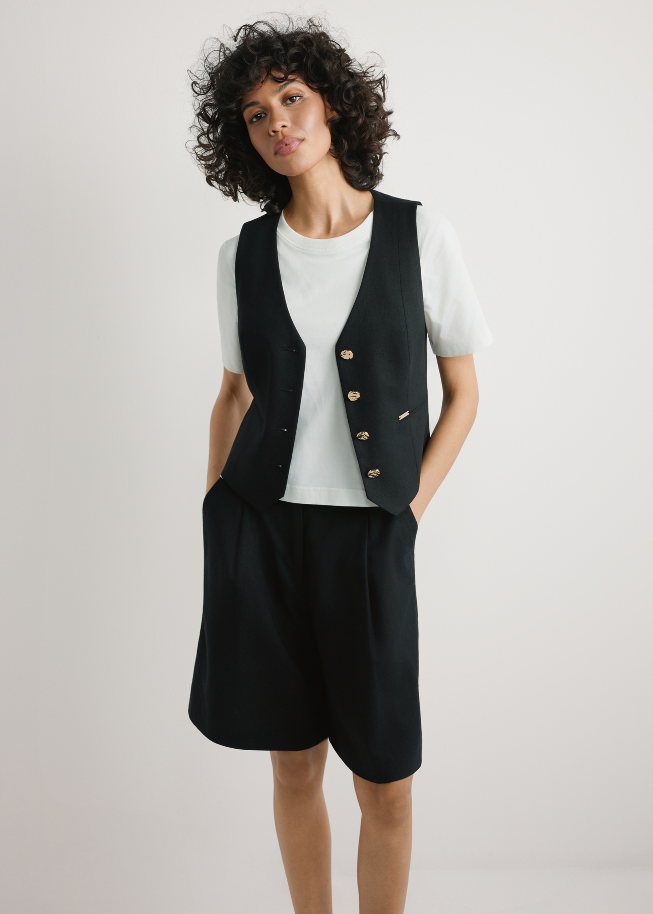 Black viscose and linen vest KAMDT-0038-99(W26) - front view of the product, on a model, on a light background, visible silhouette to the knees.