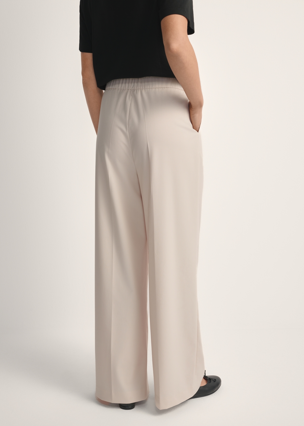 Light beige women's trousers SPODT-0119-1A(W26), back view of the product on the model. Half of the silhouette visible.