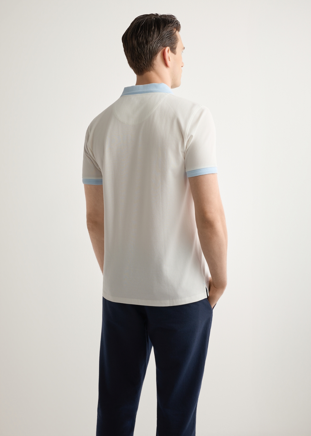 Men's cream polo shirt POLMT-0093-0B(W26), back view of the product on the model. Half of the silhouette visible.