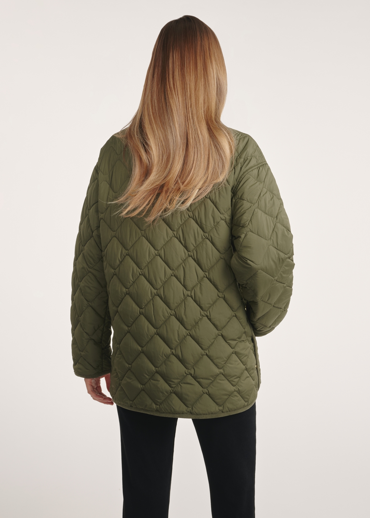 Women's jacket with collar in khaki color KURDT-0596-55(Z25), product view from the back on the model. Half of the silhouette visible.