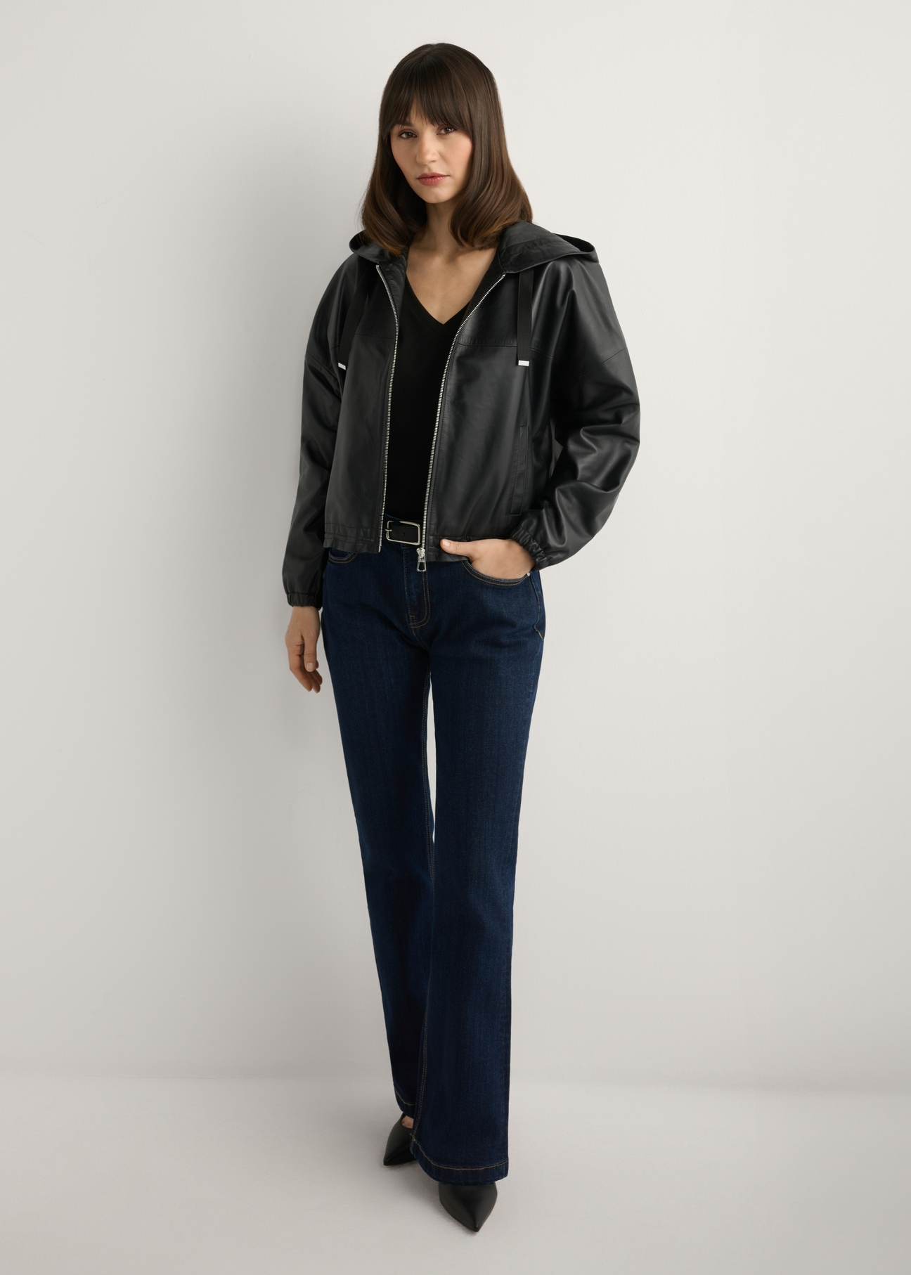 Women's black leather jacket with hood KURDS-0412-99(W26), front view of the product on the model. Full body visible.