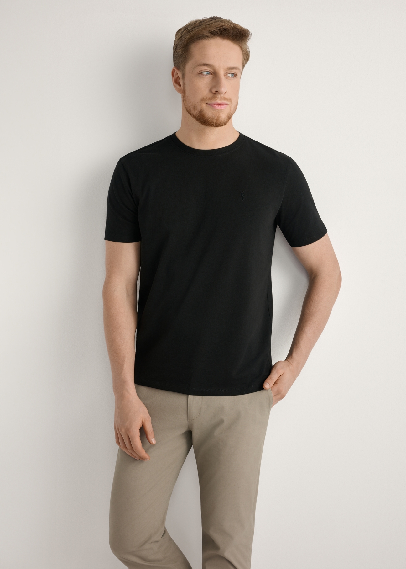 Black cotton men's T-shirt TSHMT-0120-99(Z25), front view of the product on the model, half of the silhouette visible.