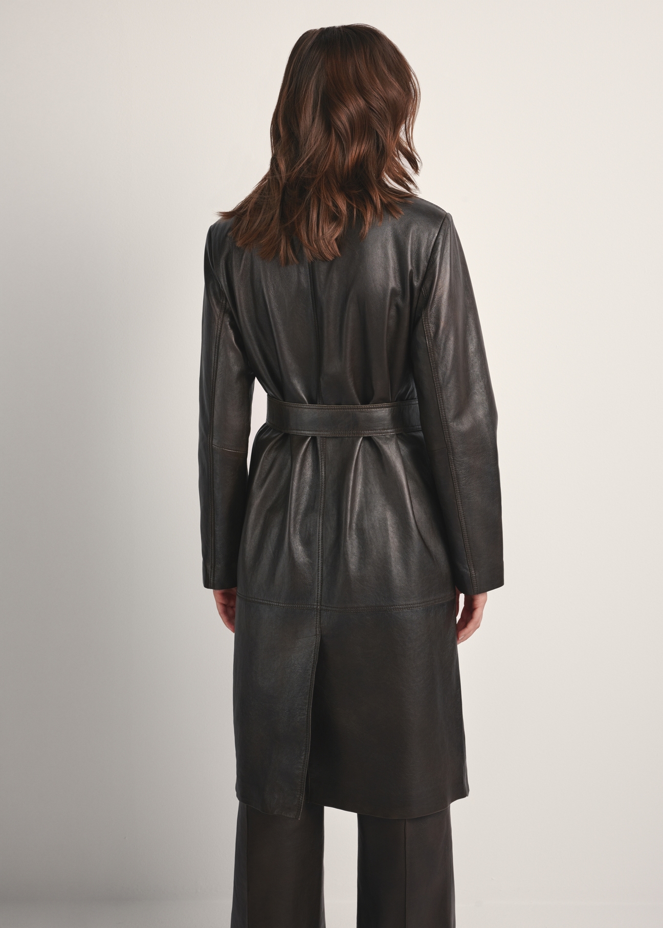 Brown long women's leather jacket KURDS-0544-2868(Z25), product view from the back on the model. Half of the silhouette visible.