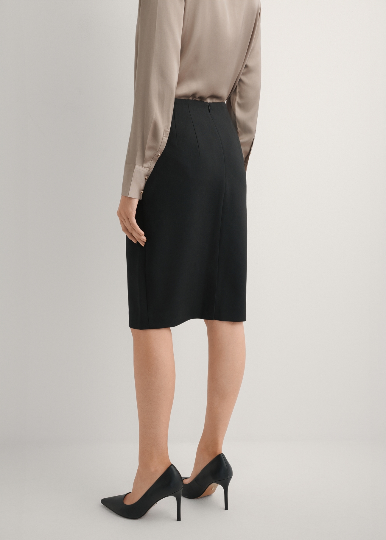 Classic black pencil skirt SPCDT-0088-99(W25), product view from the back on the model, half of the silhouette visible.