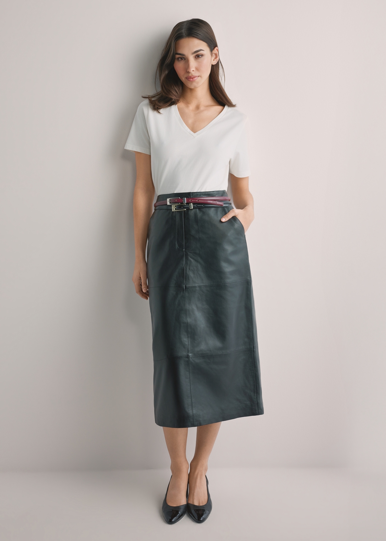 Black leather midi skirt SPCDS-0076-99(W26), front view of the product on the model. Full body visible.