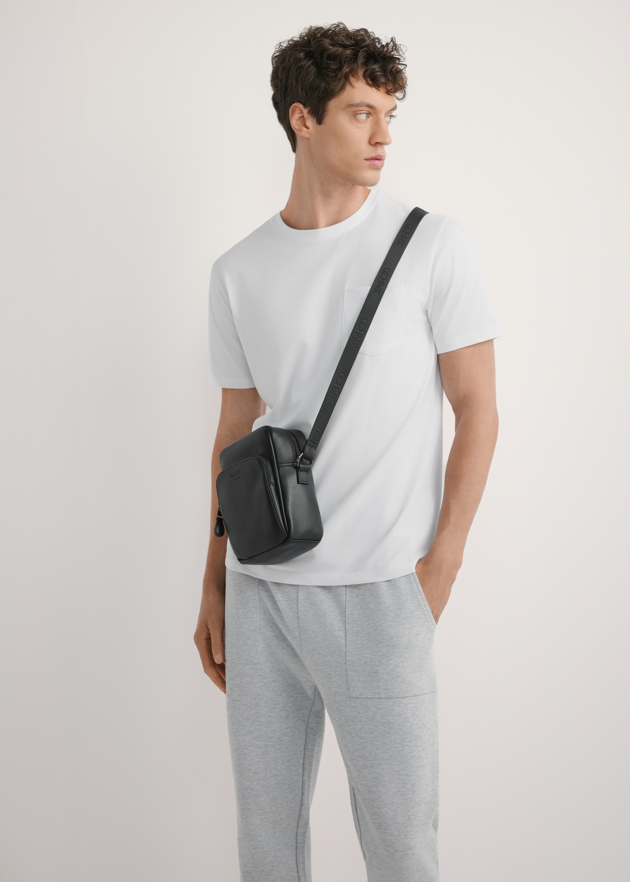 Black men's leather bag TORMS-0485R-9I(W26), front view of the product on the model, half of the silhouette visible.