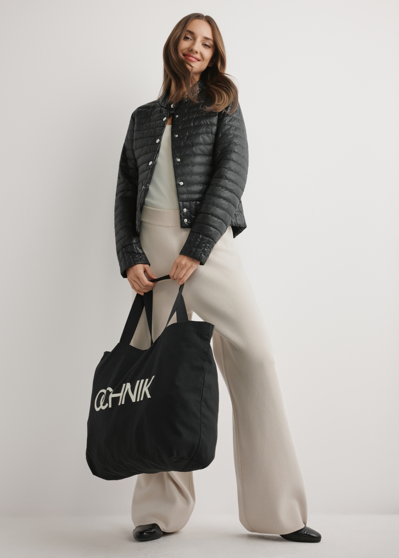 Black cotton bag TOREN-0136-9P(W26), product view in model's hand. Full body visible.