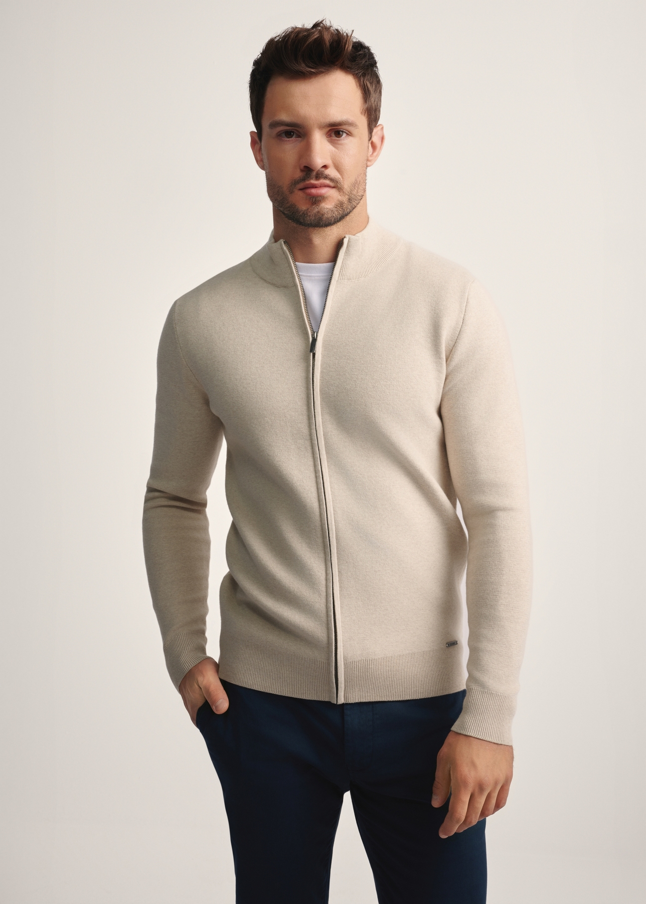 Beige men's cardigan SWEMT-0149-81(Z25), front product view on model. Half silhouette visible.