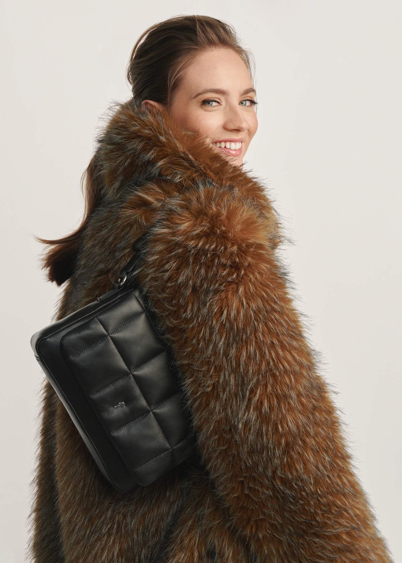 Black leather handbag TORES-1197-99(Z25) - front view of the product on a model against a white background. Half of the silhouette visible from the side.
