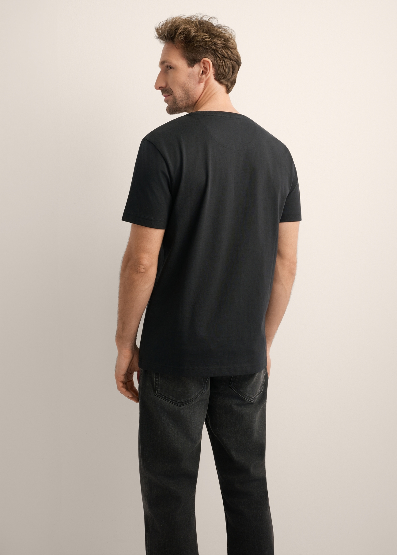 Men's black cotton T-shirt TSHMT-0154-99(Z26), back view of the product on the model. Half of the silhouette visible.