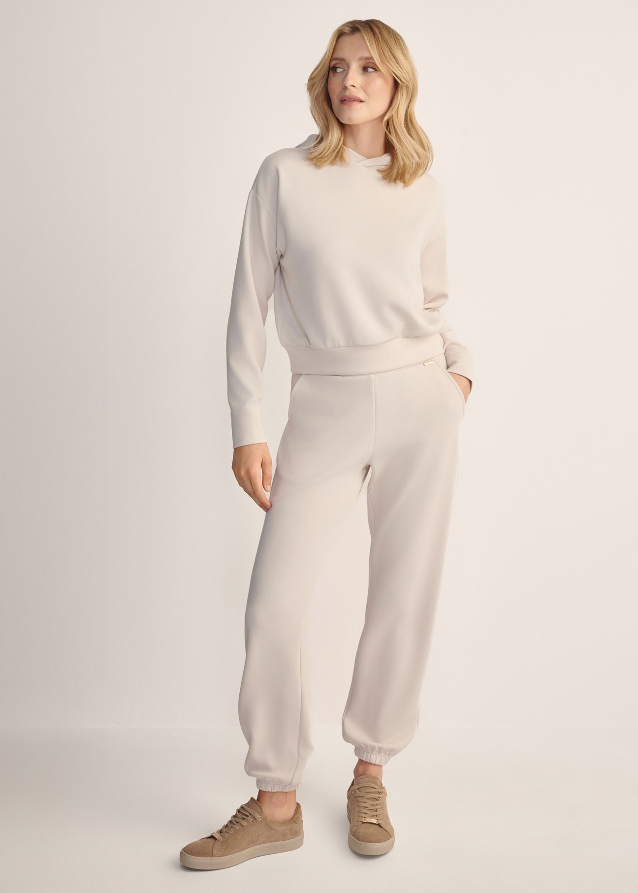 Light beige women's trousers SPODT-0117-80(Z25), front view of the product on the model. Full body visible.