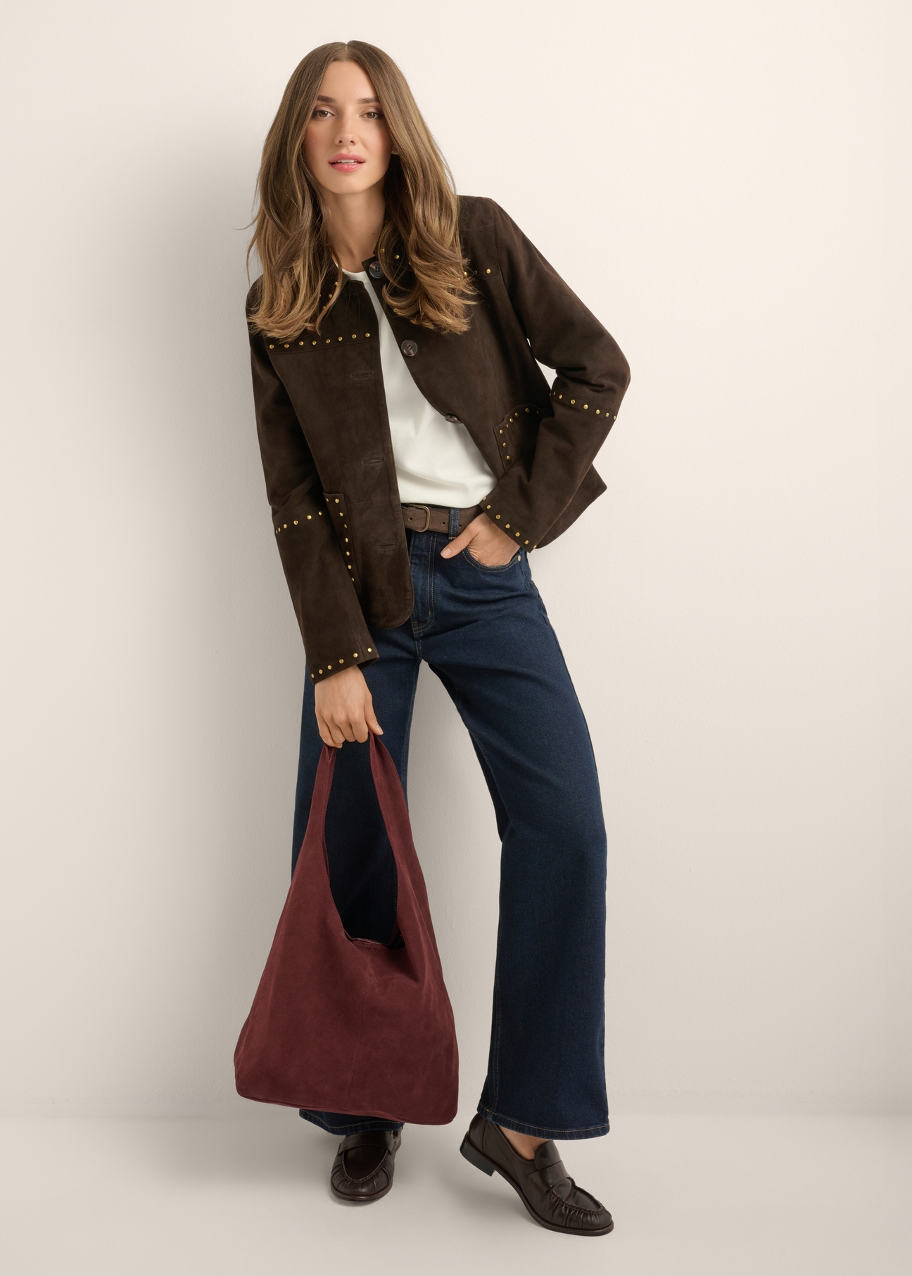 Burgundy suede shopper bag TORES-1403-4D(Z26) - view of the product held in the model's hand, against a light background. The entire silhouette is visible.