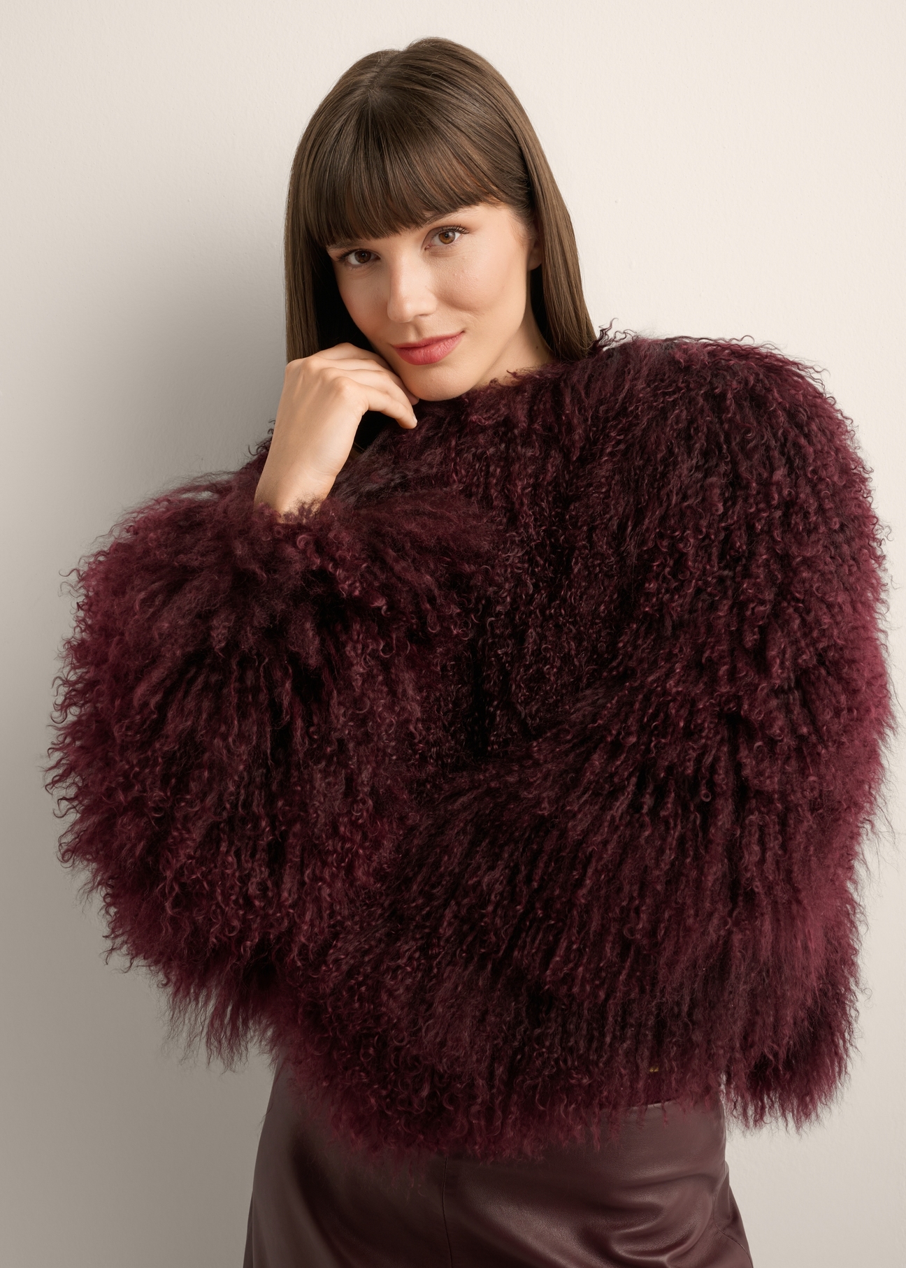 Burgundy short natural fur coat FUTDF-0104-4D(Z26), front view of the product on the model. Half of the silhouette visible.
