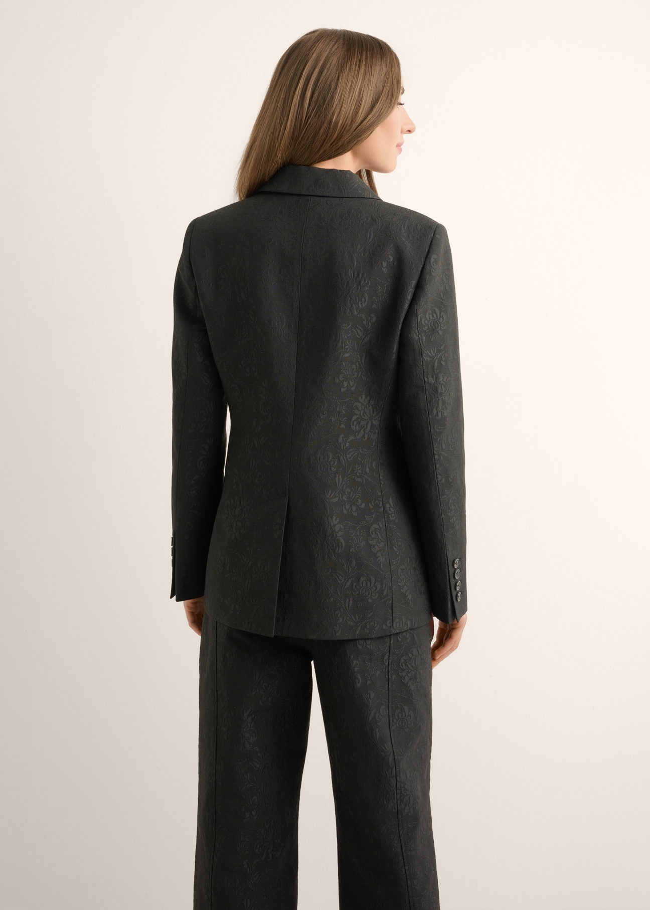 Women's black floral blazer ZAKDT-0052-99(Z26), back view of the product on the model. Half of the silhouette visible.