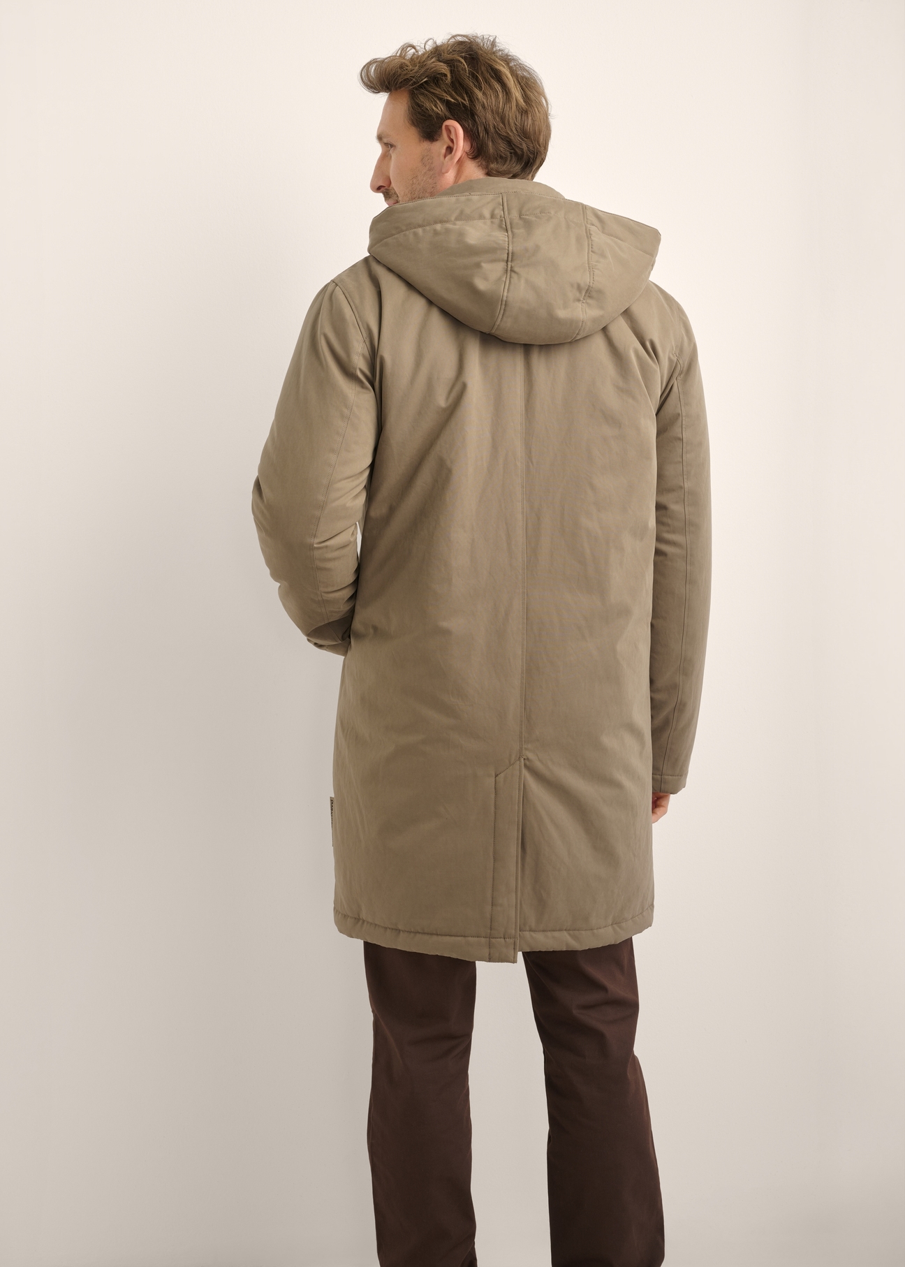 Men's long dark beige jacket KURMT-0441-1C(Z26), product view from the back on the model. Half of the silhouette visible.