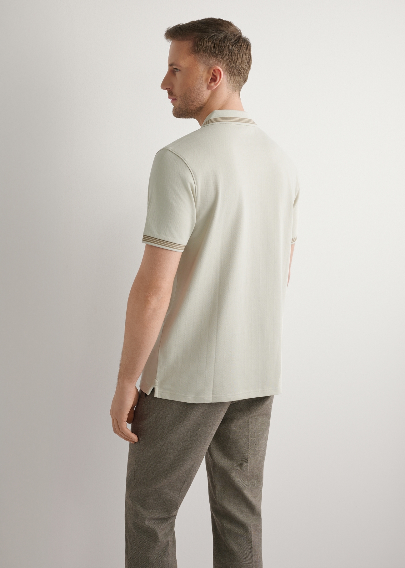Light beige polo shirt POLMT-0090-1A(W26), back view of the product on the model. Half of the silhouette visible.