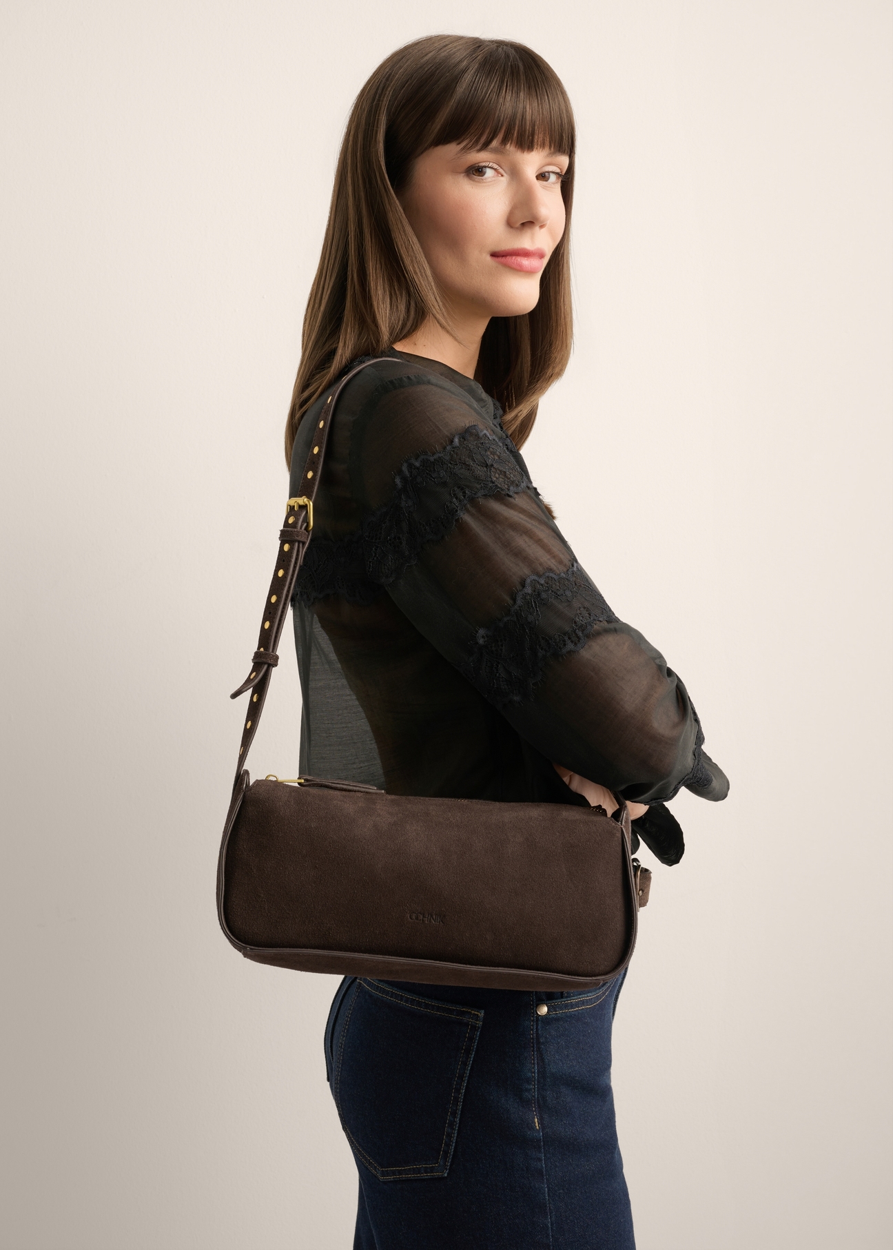 Brown suede women's handbag TORES-1383-1I(Z26) - front view of the product, held by the model on her shoulder, against a light background. Half-length silhouette visible.