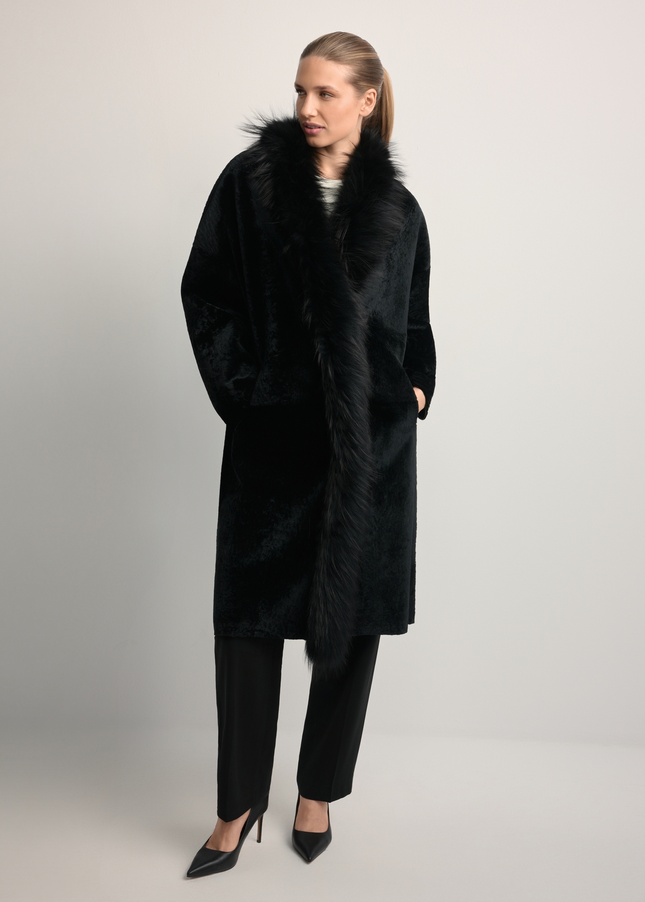 Black leather double-sided women's sheepskin coat KOZDS-0093-1396(Z25), front view of the product on the model. Full body visible.