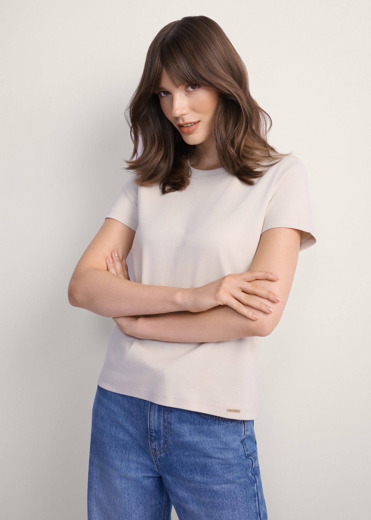 Beige cotton women's T-shirt TSHDT-0144-80(Z25), product view from the front on the model, half of the silhouette visible.