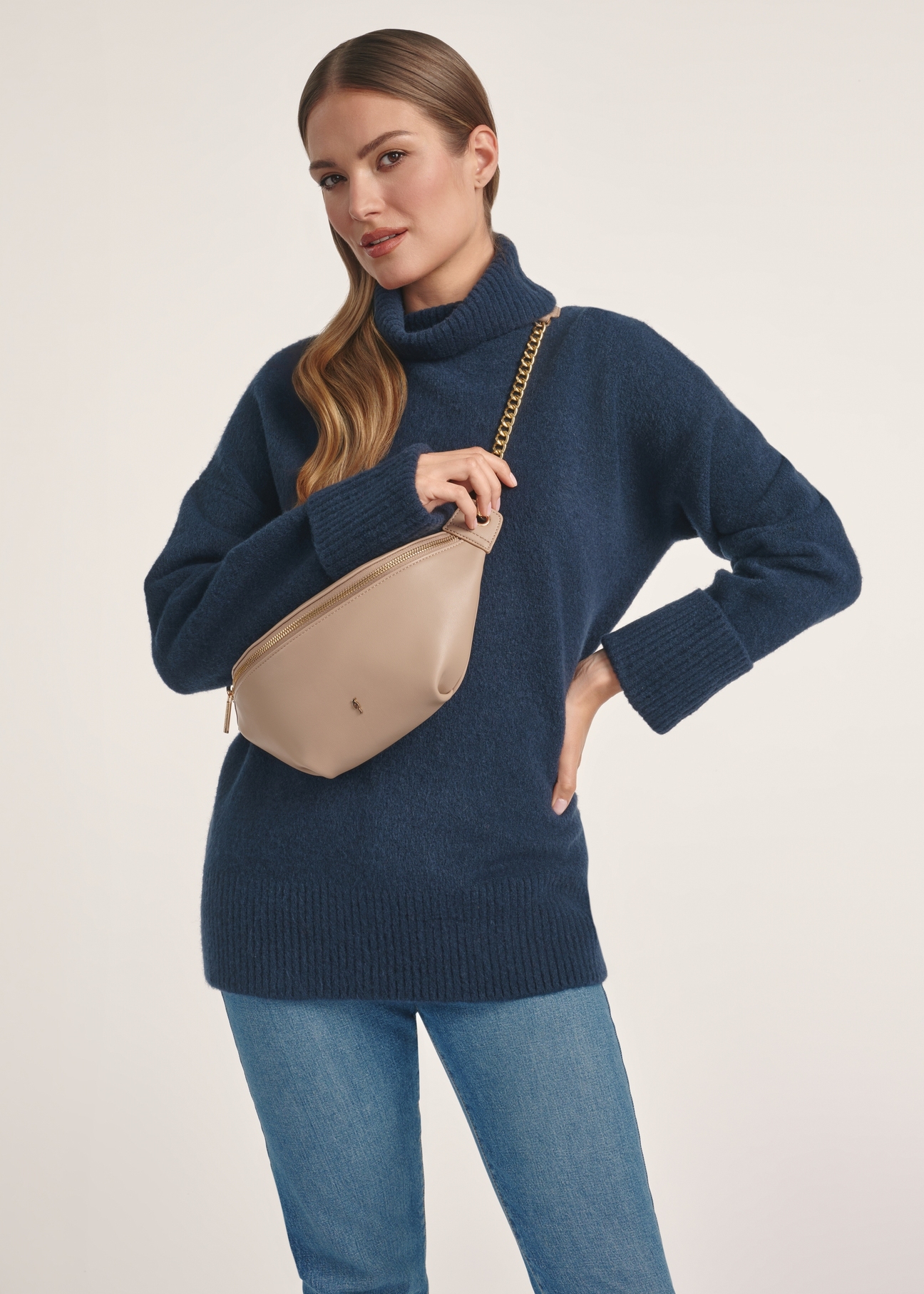 Beige women's compact waist bag TOREC-0788C-81(Z25), product view on model. Half of the figure visible.