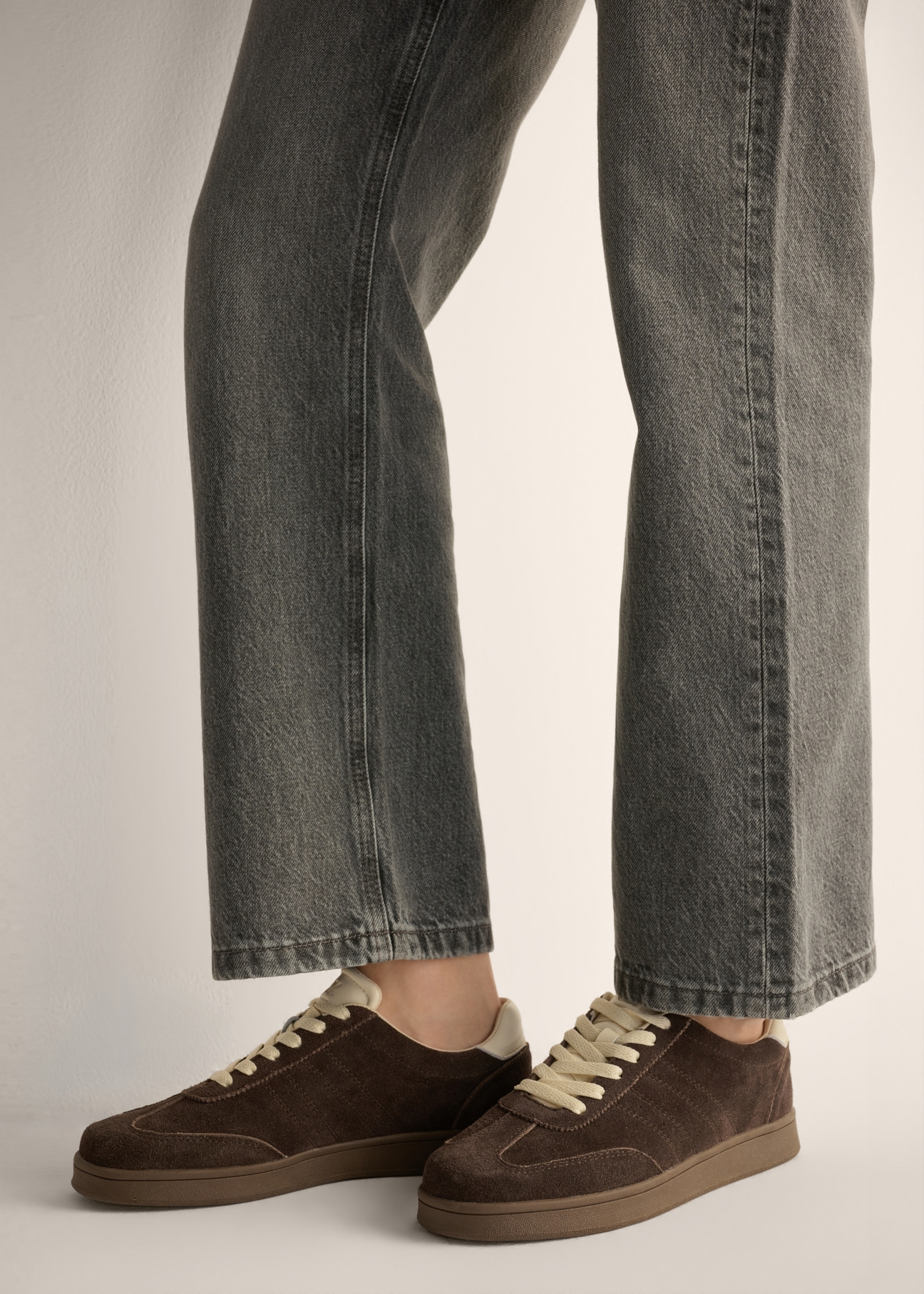 Dark brown suede sneakers BUTYD-1317-1I(Z26), side view of the product on a model. Half of the silhouette visible.