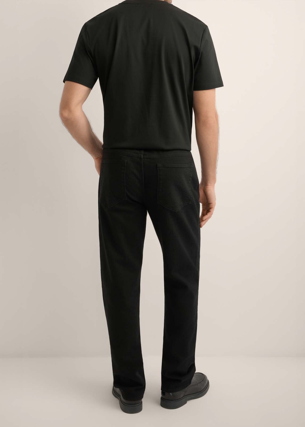 Men's black jeans JEAMT-0025-99(Z26), product view from the back on the model. Half of the silhouette visible.