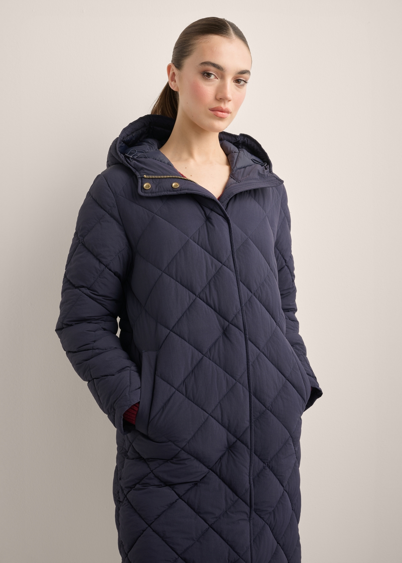 Navy blue women's quilted jacket KURDT-0667-7D(Z26), front view of the product on the model. Half of the silhouette visible.
